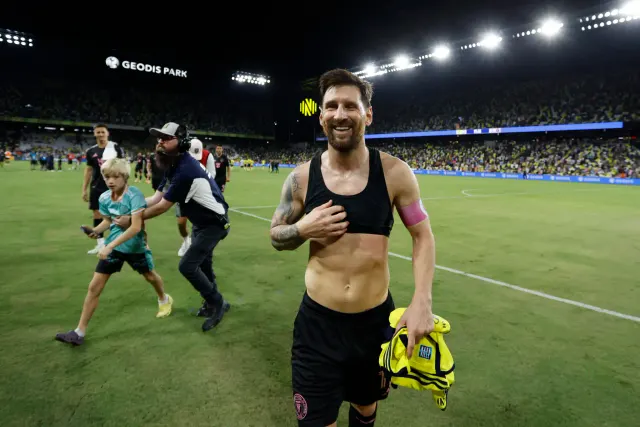 Lionel Messi smiling and walking on the soccer field after scoring his 60th career hat-trick for Inter Miami against Nashville SC in October 2025.